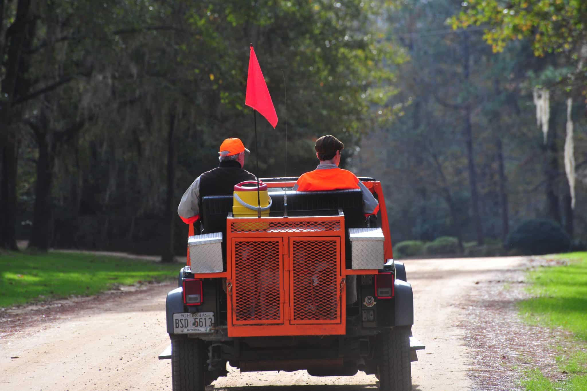 two men driving in a jeep