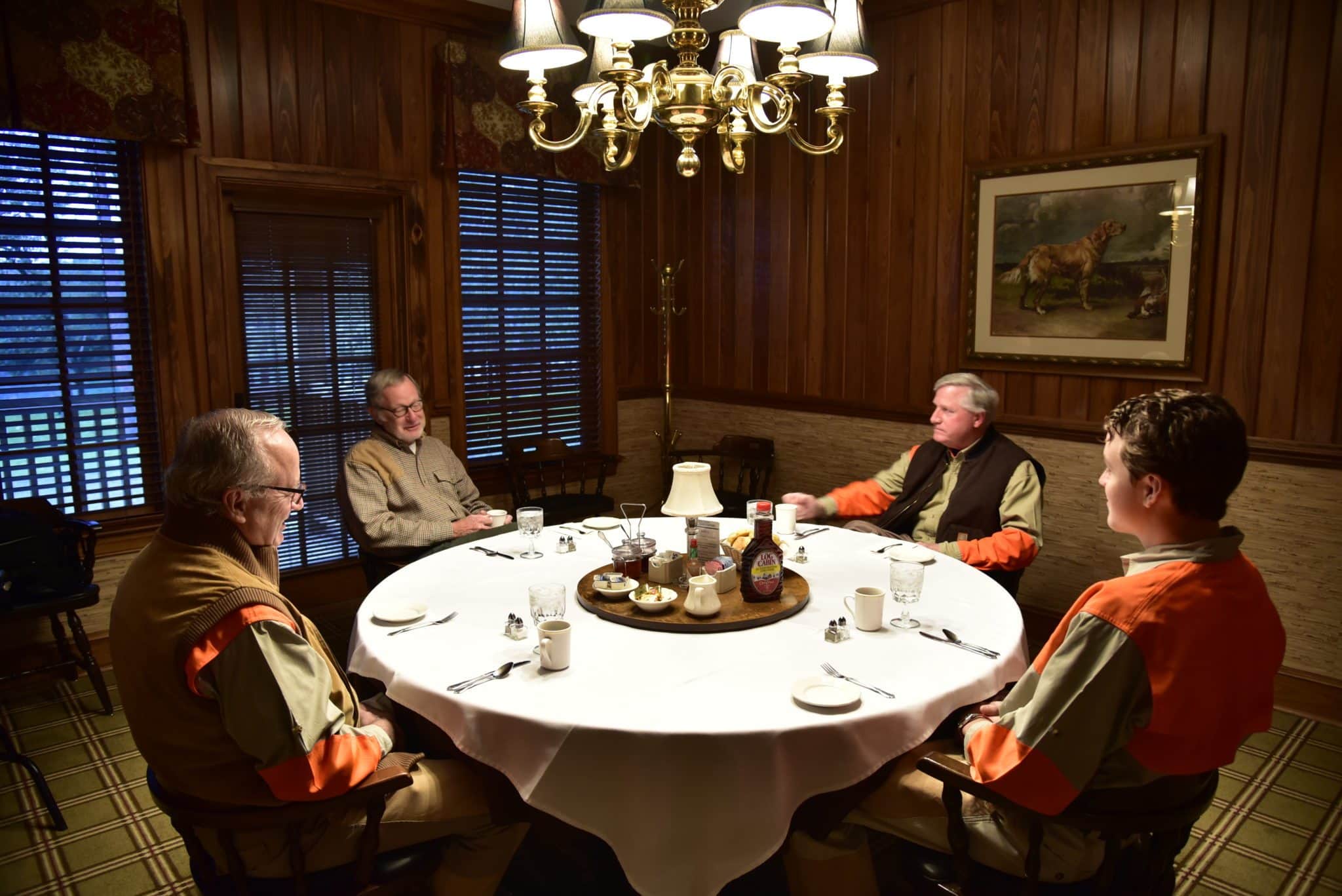 4 men gathered around the table